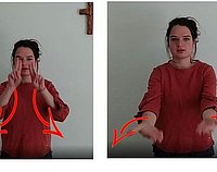 eine Frau in einem roten Pullover zeigt den Friedensgruß in Gebärde 