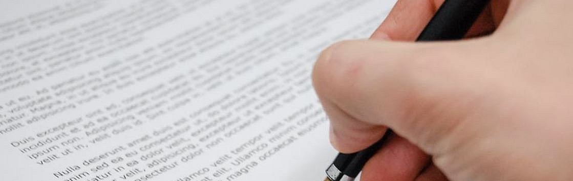 eine Hand untershreibt mit einem Füllfederhalter ein Dokument, darunter sind die Logos der MAV, Bistum Limburg und der SBV